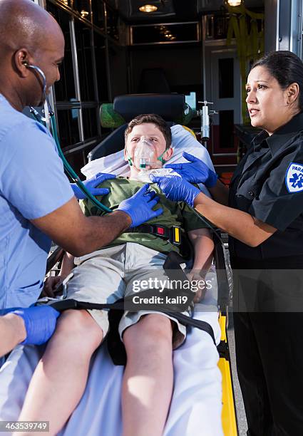 doctor and paramedic helping child - hospital gurney stock pictures, royalty-free photos & images