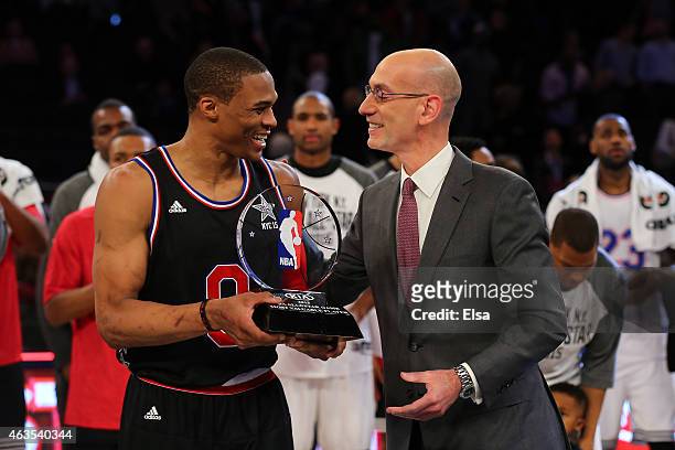Commissioner Adam Silver awards the MVP Trophy to Russell Westbrook of the Oklahoma City Thunder and the Western Conference after defeating the...