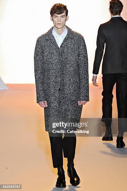 Model walks the runway at the Wooyoungmi Autumn Winter 2014 fashion show during Paris Menswear Fashion Week on January 18, 2014 in Paris, France.