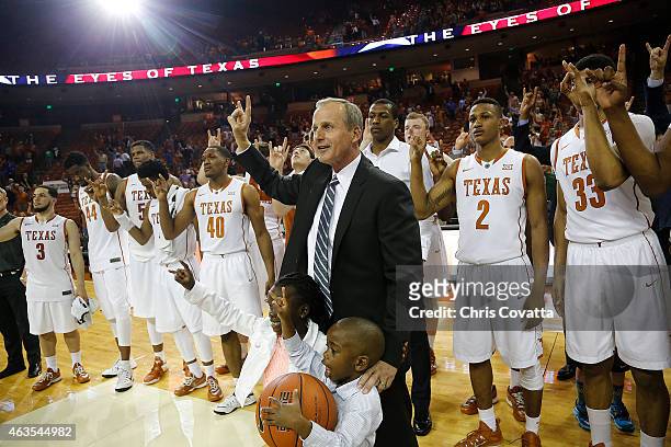 Head coach Rick Barnes of the Texas Longhorns and his team flash the Hook 'em Horns sign after defeating the TCU Horned Frogs at the Frank Erwin...