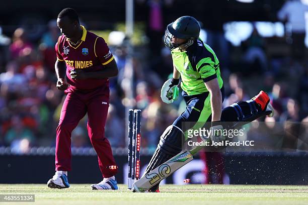 Kevin O'Brien of Ireland is run out by Jerome Taylor of the West Indies during the 2015 ICC Cricket World Cup match between the West Indies and...