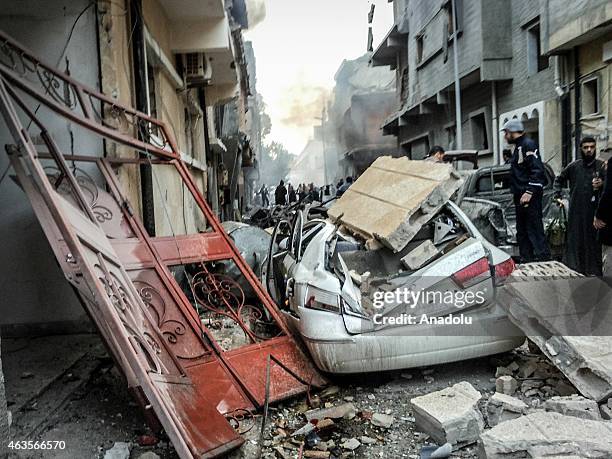 Destroyed car by debris of a building seen after Egypt's army warplanes carried out airstrikes in neighboring Libya against targets belonging to the...