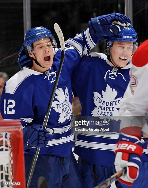 Mason Raymond and Jake Gardiner of the Toronto Maple Leafs celebrate a second period goal during NHL game action against the Montreal Canadiens...