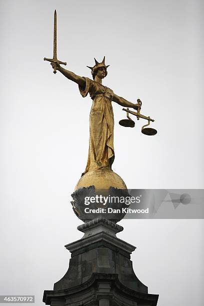 Statue of the scales of justice stands above the Old Bailey on February 16, 2015 in London, England.