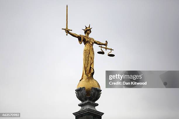 Statue of the scales of justice stands above the Old Bailey on February 16, 2015 in London, England.