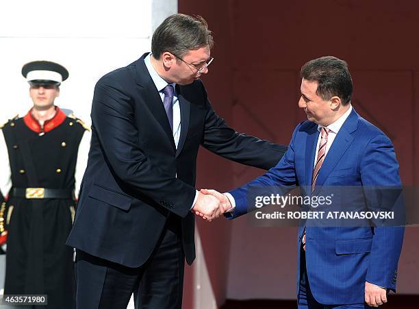 Macedonian Prime Minister Nikola Gruevski shakes hands with Serbian counterpart Aleksandar Vucic and his after their meeting in Skopje on February...