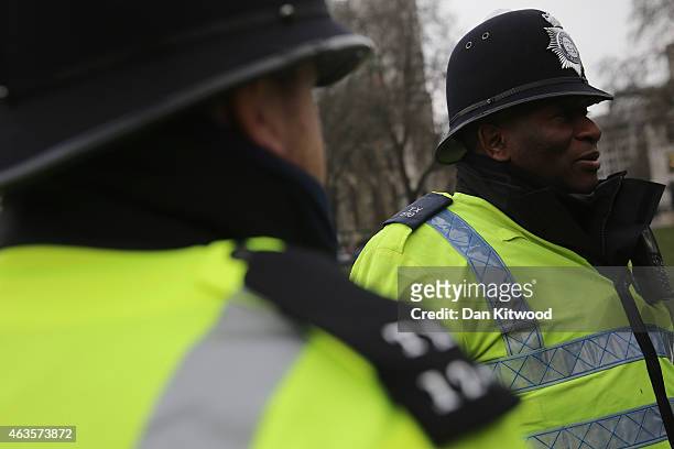 Police Officers stand in Parliament Square on February 15, 2015 in London, England.