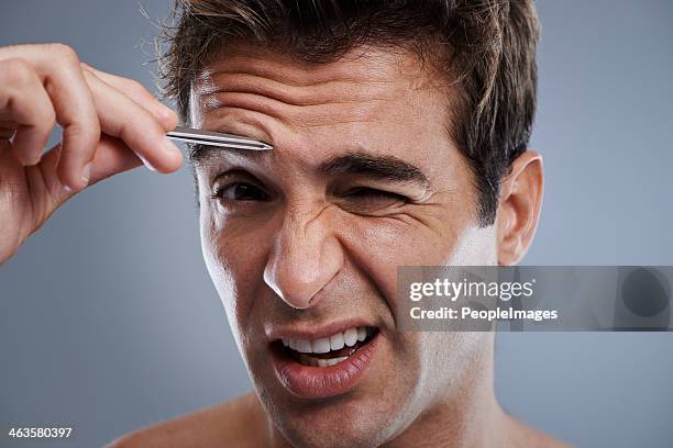 grooming himself isn't always pleasant - male hair removal stockfoto's en -beelden