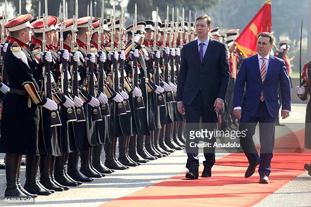 Serbian Prime Minister Alaksandar Vucic accompanied by his Macedonian counterpart Nikola Gruevski as they inspect the honor guard in front of the...