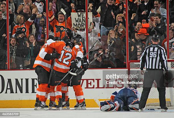 Braydon Coburn, Michael Raffl, and Jakub Voracek of the Philadelphia Flyers celebrate Voracek's game-tying goal in the third period against Kevin...