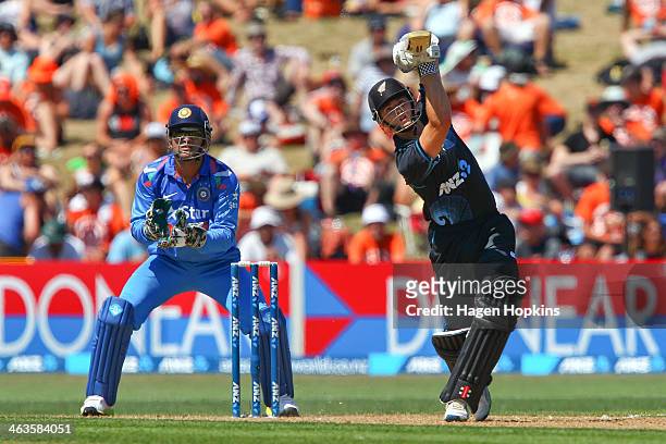 Kane Williamson of New Zealand bats while MS Dhoni of India looks on during the first One Day International match between New Zealand and India at...