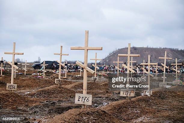 The graves of fighters without names marked with numbers in the cemetery of Mospyne on February 16, 2015 in Mospyne, Ukraine. Four rebel fighters...