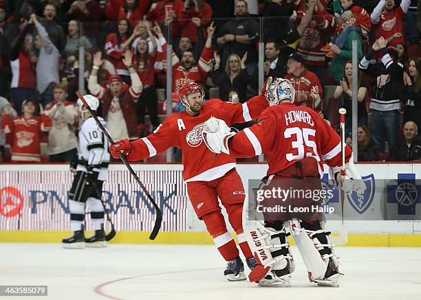 Niklas Kronwell of the Detroit Red Wings celebrates a shootout win over the Los Angeles Kings with goalie Jimmy Howard at Joe Louis Arena on January...