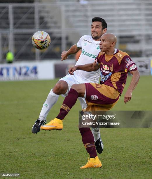 Jonathan Estrada player of Deportes Tolima vies for the ball with Andres Perez player of Deportivo Cali for the 4th date of the Aguila League I 2015...