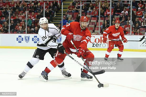 Kyle Quincey of the Detroit Red Wings battles for the puck against Jarret Stoll of the Los Angeles Kings during the third period of the game at Joe...