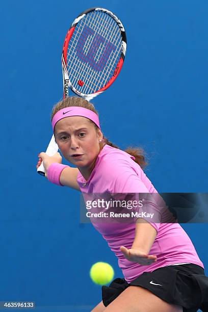 Jelena Ostapenko of Latvia plays a forehand in her first round junior girls' match against Kaylah McPhee of Australia during the 2014 Australian Open...