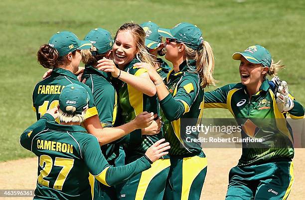 Holly Ferling of Australia celebrates with team mates after taking the wicket of Charlotte Edwards of England during game one of the women's One Day...