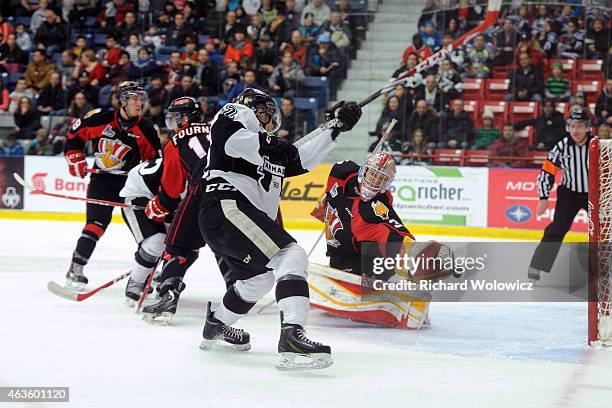 Danick Martel of the Blainville-Boisbriand Armada shoots the puck on Philippe Cadorette of the Baie Comeau Drakkar during the QMJHL game at Centre...