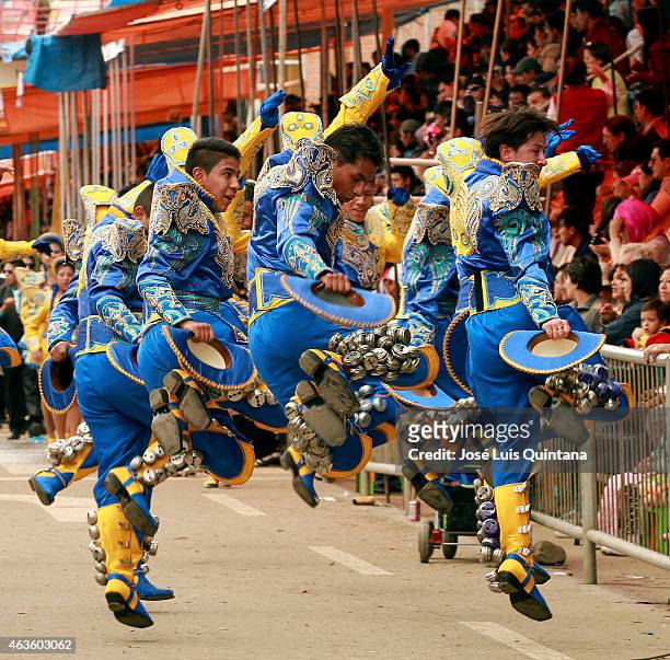 Performers disguised as Caporales dance through 6 de Agosto Avenue during the traditional Entrada del Carnaval de Oruro on February 14, 2015 in...