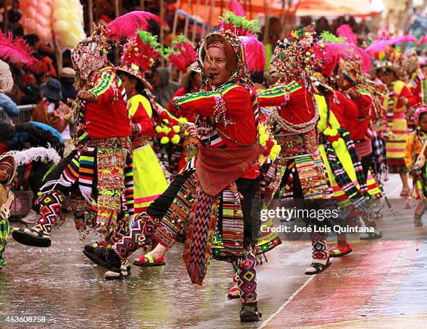 Performers disguised as Tinkus walk through 6 de Agosto Avenue during the traditional Entrada del Carnaval de Oruro on February 14, 2015 in Oruro,...