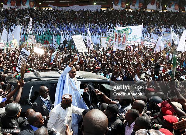 Nigerian opposition presidential candidate Muhammadu Buhari waves to his supporters as he arrives for an election campaign rally in Maiduguri,...