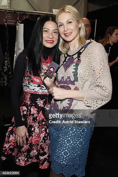 Designer Vivienne Tam and Kelly Rutherford prepare backstage at the Vivienne Tam fashion show during Mercedes-Benz Fashion Week Fall 2015 at The...