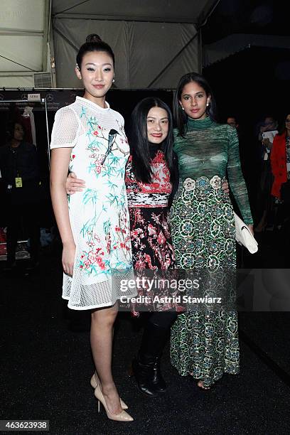 Karen Hu, designer Vivienne Tam and Thatiana Diaz prepare backstage at the Vivienne Tam fashion show during Mercedes-Benz Fashion Week Fall 2015 at...