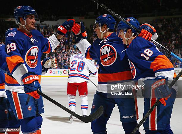 Ryan Strome of the New York Islanders is congratulated by Travis Hamonic and Brock Nelson after Strome scored in the second period against the New...