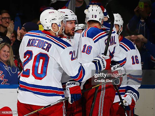 Kevin Klein of the New York Rangers is congratulated by teammates Chris Kreider,Marc Staal and Derick Brassard after Klein scored the game winner in...