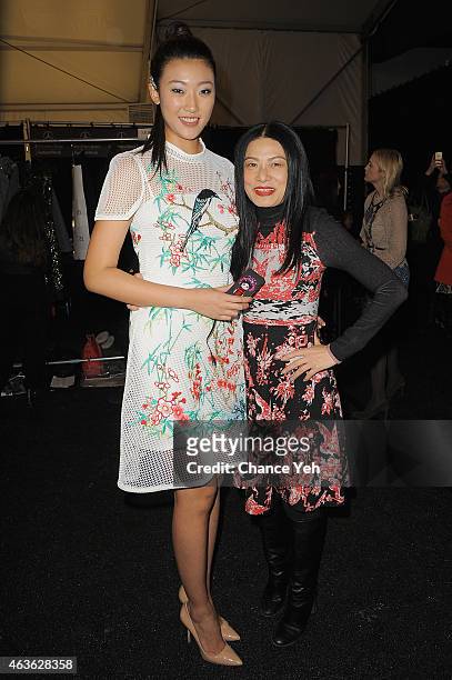 Karen Hu and designer Vivienne Tam pose backstage at the Vivienne Tam Fashion Show during Mercedes-Benz Fashion Week Fall 2015 at The Theatre at...
