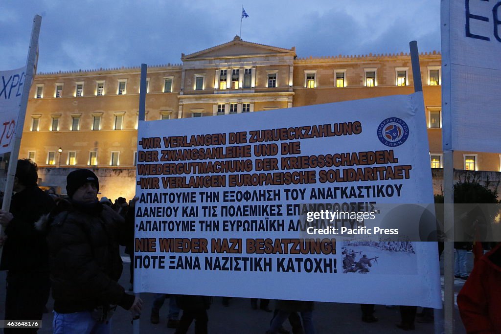 A banner calls in German and Greek for the repayment of the...