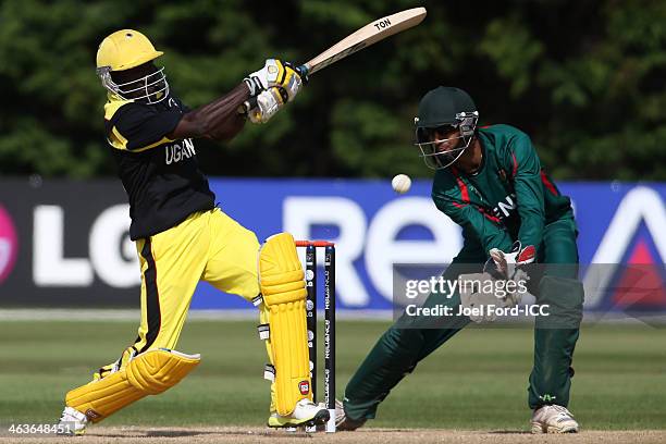 Frank Nsubuga of Uganda plays a shot in fron of wicketkeeper Ifran Karim of Kenya during an ICC World Cup qualifying match between Kenya and Uganda...