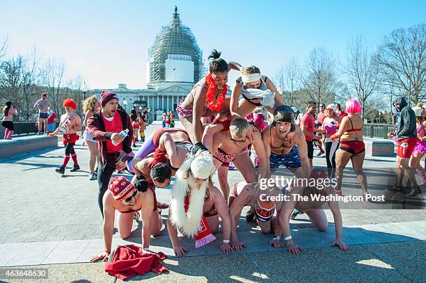 Group of friends try to create a human pyramid in the undies in front of the U.S. Capitol as they take a short break from the Cupid's Undie Run...