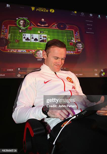 Wayne Rooney of Manchester United plays poker at a press conference to launch Manchester United's partnership with KamaGames and unveil the first in...