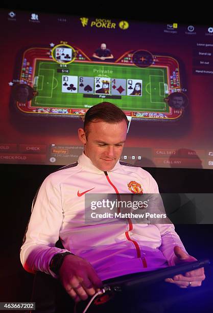 Wayne Rooney of Manchester United plays poker at a press conference to launch Manchester United's partnership with KamaGames and unveil the first in...