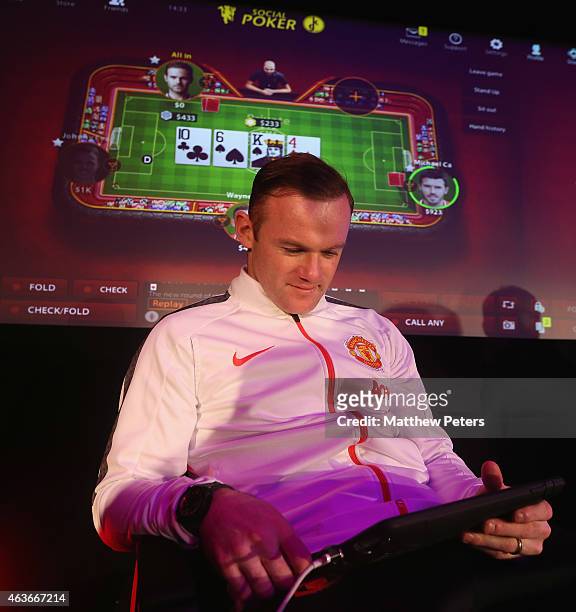 Wayne Rooney of Manchester United plays poker at a press conference to launch Manchester United's partnership with KamaGames and unveil the first in...