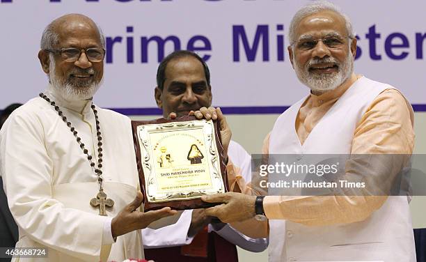 Prime Minister Narendra Modi presented a memento by Cardinal George Alencherry during a function to celebrate the elevation of Kuriakose Elias...