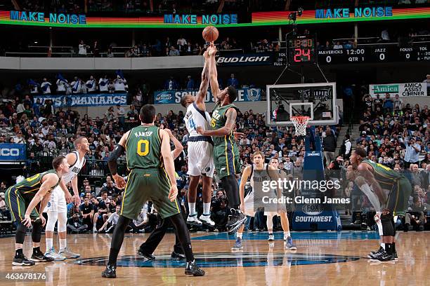 Greg Smith of the Dallas Mavericks jumps for the tip off against Derrick Favors of the Utah Jazz on February 11, 2015 at the American Airlines Center...