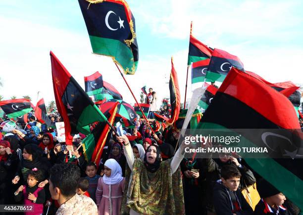 Libyans celebrate in Tripoli's landamark Martyrs square on February 17, 2015 the upcoming fourth anniversary of the Libyan revolution which toppled...