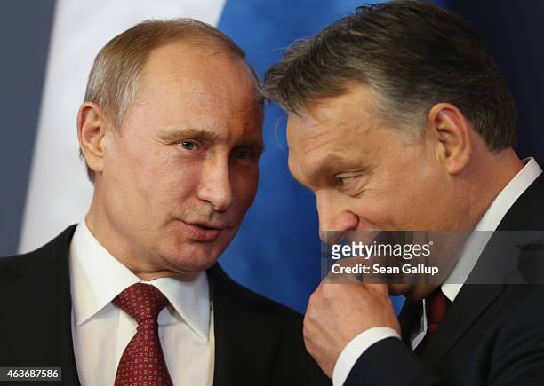 Russian President Vladimir Putin and Hungarian Prime Minister Viktor Orban converse during a signing ceremony of several agreements between the two...