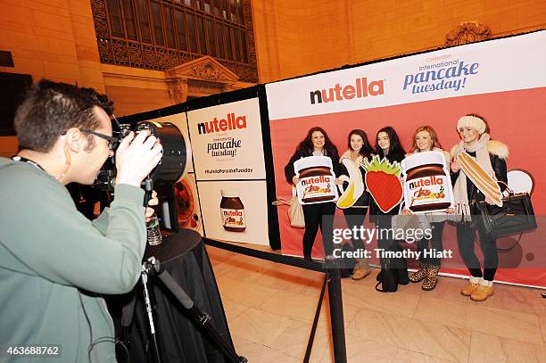 Nutella fans pose in front of customized photo both and share with friends via social media at Nutella's International Pancake Tuesday event on...