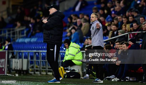 Cardiff manager Russell Slade and new coach Paul Trollope react during the Sky Bet Championship match between Cardiff City and Blackburn Rovers at...