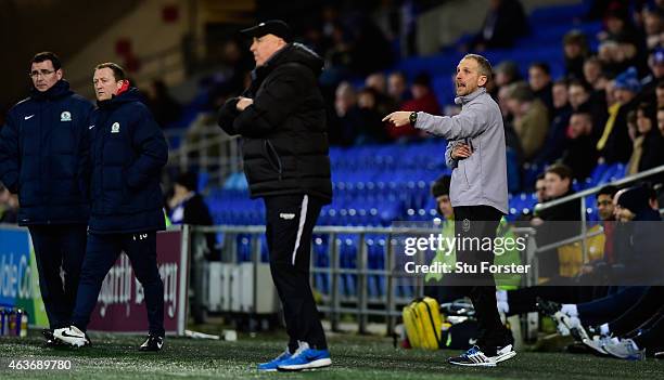 Cardiff manager Russell Slade and new coach Paul Trollope react during the Sky Bet Championship match between Cardiff City and Blackburn Rovers at...