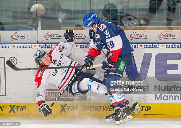 Brandon Yip of Adler Mannheim gives a Bodycheck to Jonas Mueller of Eisbaeren Berlin during the game between Adler Mannheim and Eisbaeren Berlin on...