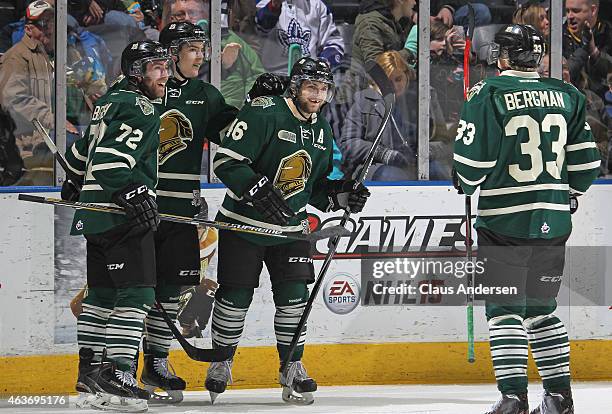 Aaron Berisha of the London Knights celebrates his goal with teammates Matt Rupert, Julius Bergman, and Aiden Jamieson against the Saginaw Spirit...