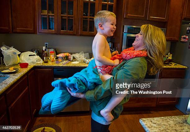 Traci Wise plays their son, Luke Wise at her home on February 3, 2013 in Puyallup, Wa. Jean and Mary Wise of Camden, Arkansas, parents of four, lost...
