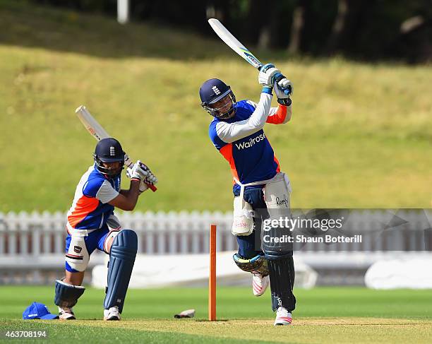 Jos Buttler of England plays a shot as Ravi Bopara practice swings during an England nets session at Basin Reserve on February 18, 2015 in...