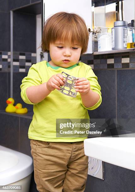 child with pills - prescription drugs dangers stock pictures, royalty-free photos & images