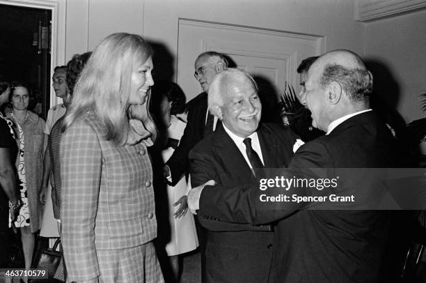 Arthur Fiedler greets incoming Boston Symphony Orchestra director William Steinberg; left: Joan Kennedy, Symphony Hall, Boston, Massachusetts, 1969.