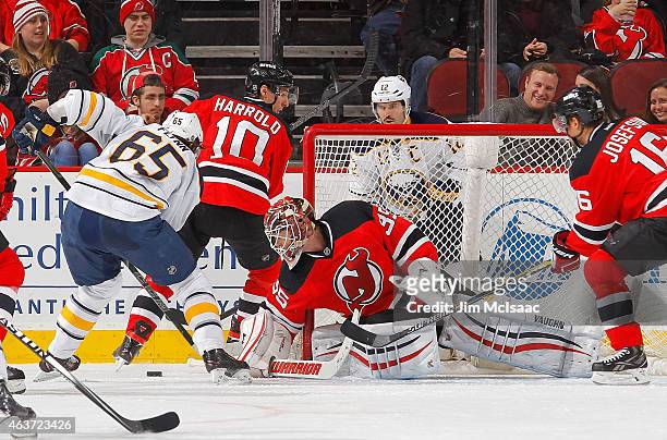 Cory Schneider of the New Jersey Devils defends the net in the second period against Brian Flynn of the Buffalo Sabres at the Prudential Center on...